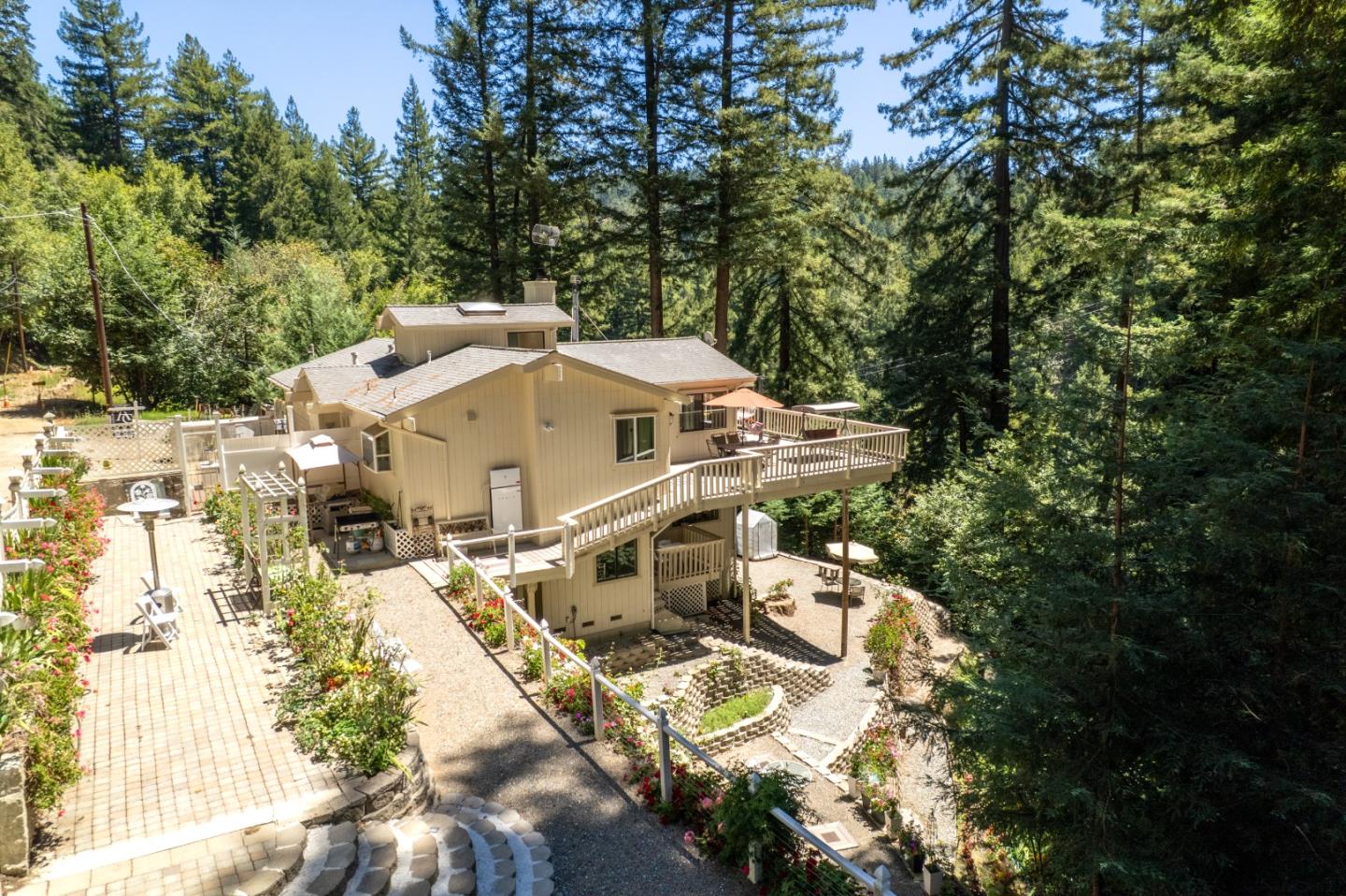 16855 Redwood Lodge Road, with a raised deck and garden patios among trees.
